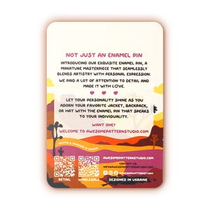 May include: A pink and orange card with a desert landscape background. The card features text that reads "Not just an enamel pin" and "Welcome to AwesomePatternStudio.com". The card also includes two QR codes labeled "Retail" and "Wholesale".