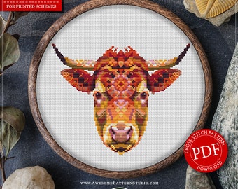 May include: A counted cross stitch pattern featuring a cow design, displayed in a wooden embroidery hoop. The cow's head is rendered in shades of orange, yellow, and brown. The pattern is available for instant download. The design measures 6.94 x 5.56 inches.
