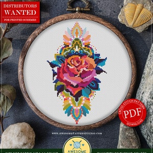 May include: A counted cross stitch pattern for instant download featuring a colorful mandala rose design. The pattern is 70 x 120 stitches and requires 20 DMC colors. The pattern is available as a PDF download.