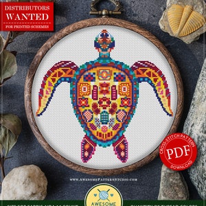 May include: A cross-stitch pattern featuring a colorful turtle design, framed in a wooden hoop. The turtle is rendered in shades of blue, yellow, red, and purple. The text "Mandala Turtle" and "PDF Download" are visible. The pattern size is 7.06 x 7.19 inches.