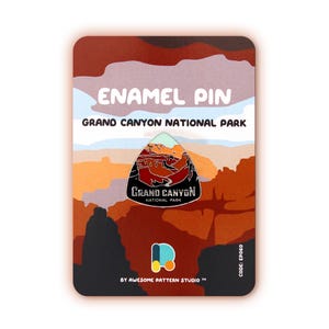 Puede incluir: Un pin de esmalte con un diseño del Gran Cañón. El pin tiene un borde negro con una colorida ilustración del cañón. El fondo es un degradado de naranja, marrón y blanco. El texto "ENAMEL PIN" y "GRAND CANYON NATIONAL PARK" están en la parte superior.