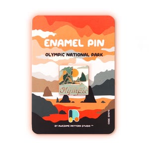 May include: Enamel pin featuring a landscape design with the text "Olympic" and "Olympic National Park." The pin is on a colorful card with the text "ENAMEL PIN" and "BY AWESOME PATTERN STUDIO." The pin has green, orange, and blue colors.
