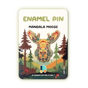 May include: Enamel pin with a mandala moose design in red, yellow, green, and gold. The pin is displayed on a card with the text "ENAMEL PIN MANDALA MOOSE" and a forest scene. The code "EP077" is visible on the card.