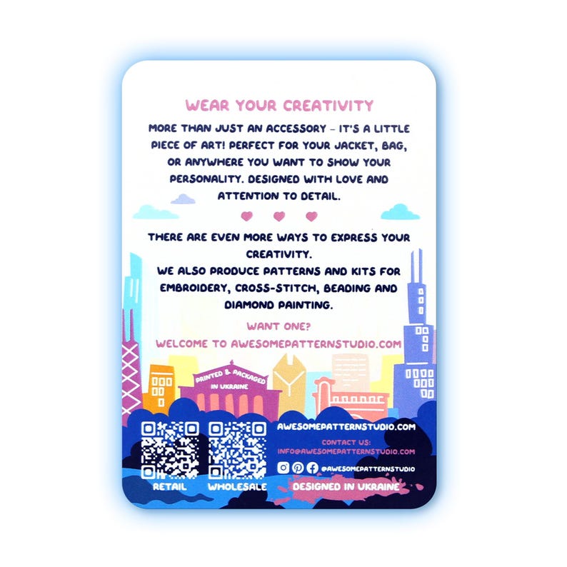 May include: A white rectangular card with a blue border features text promoting creativity and art. It includes the text "WEAR YOUR CREATIVITY" and "AWESOMEPATTERNSTUDIO.COM". The card also displays a cityscape illustration and QR codes.