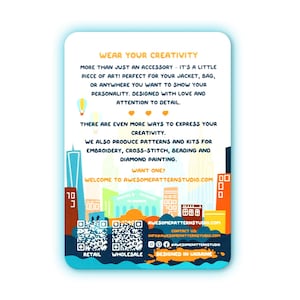 May include: A white rectangular card with a blue border features text that reads "WEAR YOUR CREATIVITY." It also includes a cityscape illustration and QR codes for retail and wholesale. The card promotes patterns and kits for embroidery, cross-stitch, beading, and diamond painting.