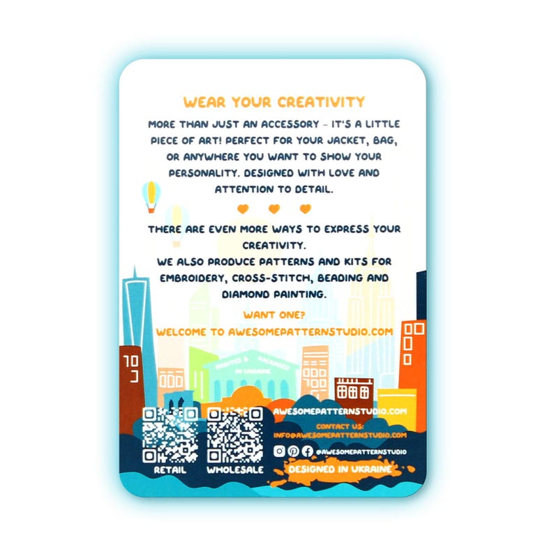May include: A white rectangular card with a blue border features text that reads "WEAR YOUR CREATIVITY." It also includes a cityscape illustration and QR codes for retail and wholesale. The card promotes patterns and kits for embroidery, cross-stitch, beading, and diamond painting.