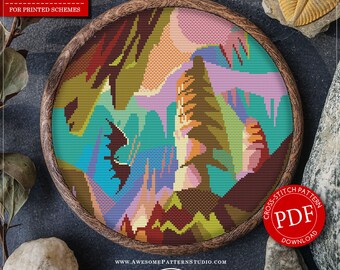 May include: A cross-stitch pattern in a wooden hoop, featuring a colorful landscape design with mountains and trees. The pattern is labeled "Carlsbad Caverns National Park Square." The image includes text that says "Distributors Wanted" and "PDF Download."