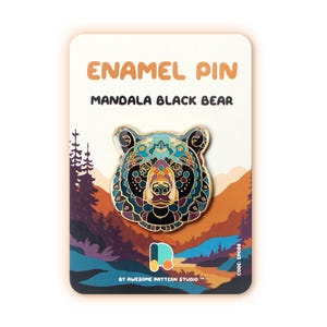 May include: Enamel pin featuring a mandala black bear design. The pin has a detailed pattern in shades of blue, teal, orange, and black. The pin is on a card with the text "ENAMEL PIN" and "MANDALA BLACK BEAR". The card has a landscape design.