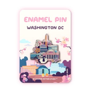May include: An enamel pin featuring Washington D.C. landmarks, including the Capitol Building and Washington Monument, with a panda and floral accents. The pin is on a pink card with the text "ENAMEL PIN WASHINGTON DC" and "BY AWESOME PATTERN STUDIO TM".