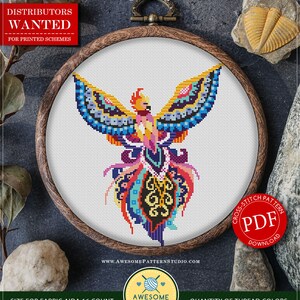 May include: A colourful cross stitch pattern of a phoenix with a mandala design. The pattern is in a wooden embroidery hoop and is ready for instant download as a PDF file. The pattern is 6.56 inches by 7.87 inches and uses 20 colours of DMC thread.