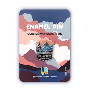 May include: Enamel pin with a mountain landscape design and the text "Glacier National Park." The pin is on a card with the text "Enamel Pin" and "By Awesome Pattern Studio." The pin is a souvenir, ideal for collectors.