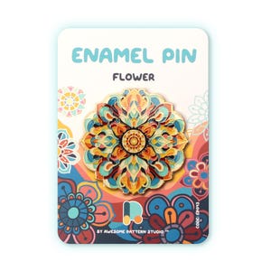 Puede incluir: Pin esmaltado con un diseño floral colorido. El pin presenta tonos de naranja, amarillo, azul y turquesa. La tarjeta trasera dice "ENAMEL PIN" y "FLOWER" en texto azul. La tarjeta tiene un patrón floral.