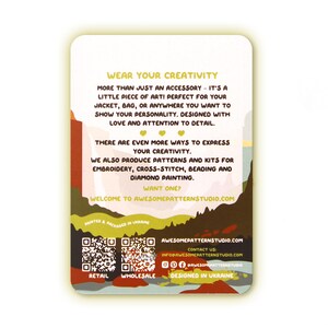 May include: A rectangular card with a colorful design and text. The card features the text "WEAR YOUR CREATIVITY" and promotes embroidery, cross-stitch, beading, and diamond painting kits. The card is designed in Ukraine.