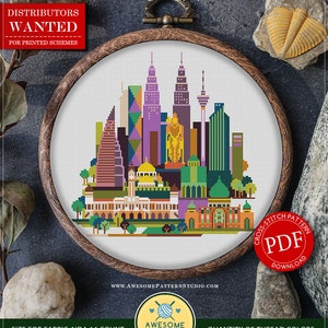 May include: A counted cross stitch pattern for Kuala Lumpur, Malaysia, featuring a colorful cityscape with skyscrapers and a mosque. The pattern is available as a PDF download and is suitable for Aida 16 count fabric. The pattern measures 8.56 inches by 8.56 inches and uses 18 DMC colors.