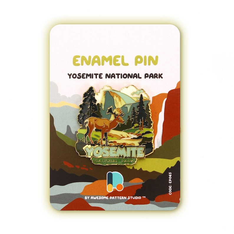 May include: An enamel pin featuring a detailed illustration of a deer in Yosemite National Park. The pin has a gold border and includes the text "YOSEMITE NATIONAL PARK" and "ENAMEL PIN". The pin is displayed on a white card with a colorful landscape design.