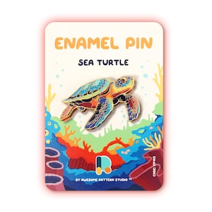 May include: An enamel pin shaped like a sea turtle with a colorful shell featuring blue, orange, and red patterns. The pin is attached to a display card labeled ENAMEL PIN SEA TURTLE, featuring a vibrant underwater coral reef illustration.