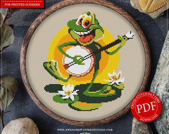 May include: A cross-stitch pattern featuring a green frog playing a banjo, set against a yellow background. The design is framed in a wooden hoop. The text reads "COUNTED CROSS STITCH PATTERN FOR INSTANT DOWNLOAD" and "DISTRIBUTORS WANTED". The fabric size is 5.94 x 6.44 inches.