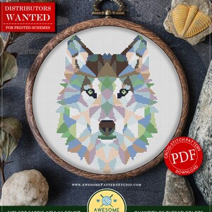 May include: A cross-stitch pattern featuring a polygonal wolf design in a wooden hoop. The pattern uses various colors, including blue, green, and brown. The text "COUNTED CROSS STITCH PATTERN FOR INSTANT DOWNLOAD" is at the top. The pattern size is 5.94 x 8.13 inches.