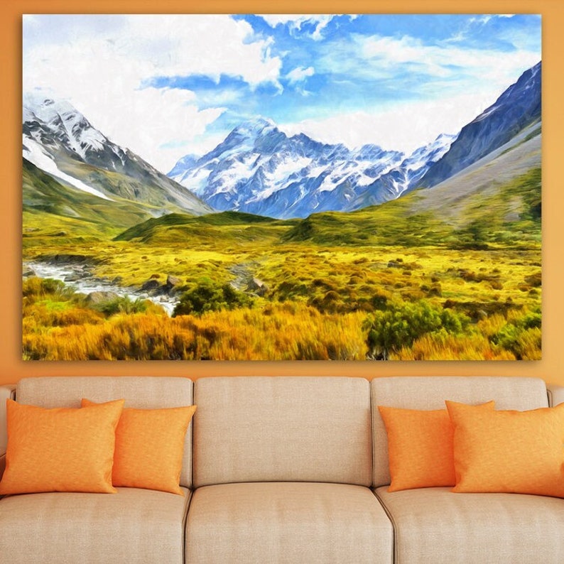May include: A painting of a mountain range with snow-capped peaks and a valley with green grass and a river. The sky is blue with white clouds.