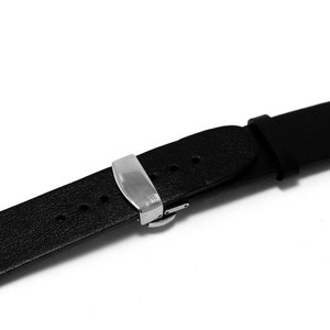 May include: A black leather watch strap with a silver buckle.