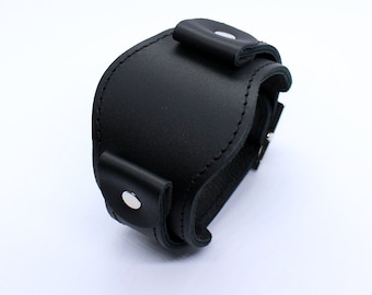 May include: Black leather watch strap with a buckle closure and silver metal accents.