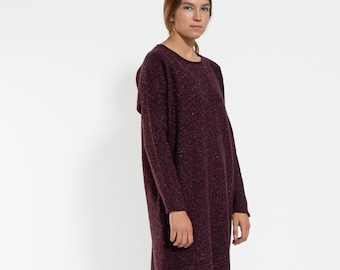 May include: A maroon sweater dress with a speckled texture. The dress has long sleeves and a round neckline.