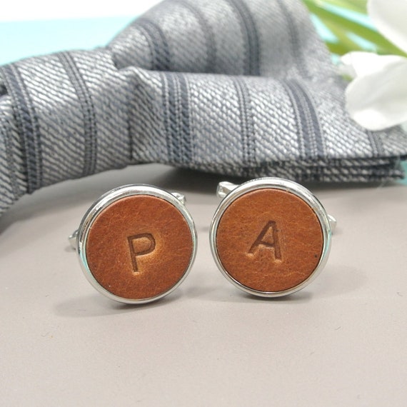 Bonded leather cufflinks stamped with personalized initials — a genuinely wearable, pocket-friendly gift with 126 favorites proving real demand for a subtle, sharp look.