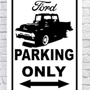 May include: A black and white metal sign featuring a vintage Ford pickup truck silhouette. The word "Ford" is above the truck, and below it, the words "PARKING ONLY" are displayed with arrows pointing left and right.