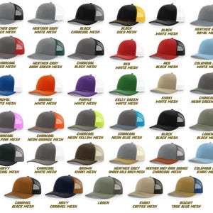 May include: A variety of trucker hats in various colors, including black, red, blue, and green. Each hat features a mesh back and a solid front panel. The hats are labeled with color combinations such as "Black Charcoal Mesh" and "Navy Charcoal Mesh".
