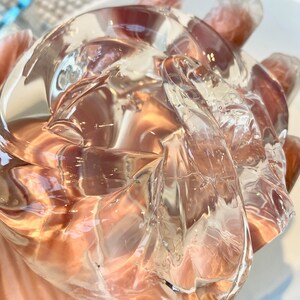 May include: A clear, translucent, and slightly textured gel-like substance in a hand.