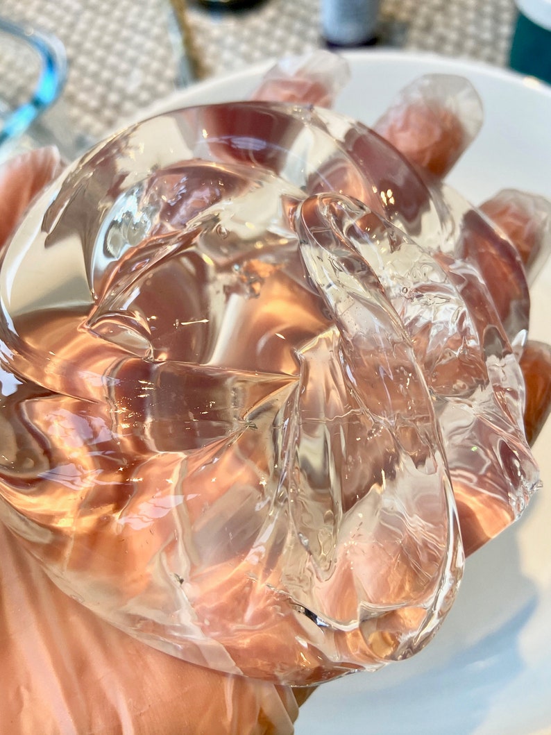 May include: A clear, translucent, and slightly textured gel-like substance in a hand.