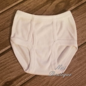 May include: White cotton underwear with a smooth texture. The underwear has a wide waistband and a classic cut.