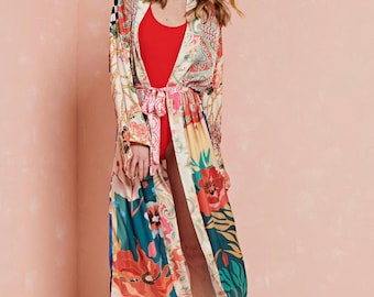 May include: A long, flowing robe with a colorful floral print. The robe has a tie belt and long sleeves. The robe is made of a soft, silky fabric.