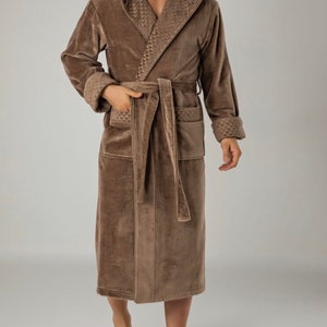 May include: A brown hooded robe with a waffle-textured lining. The robe has a sash tie and two pockets.