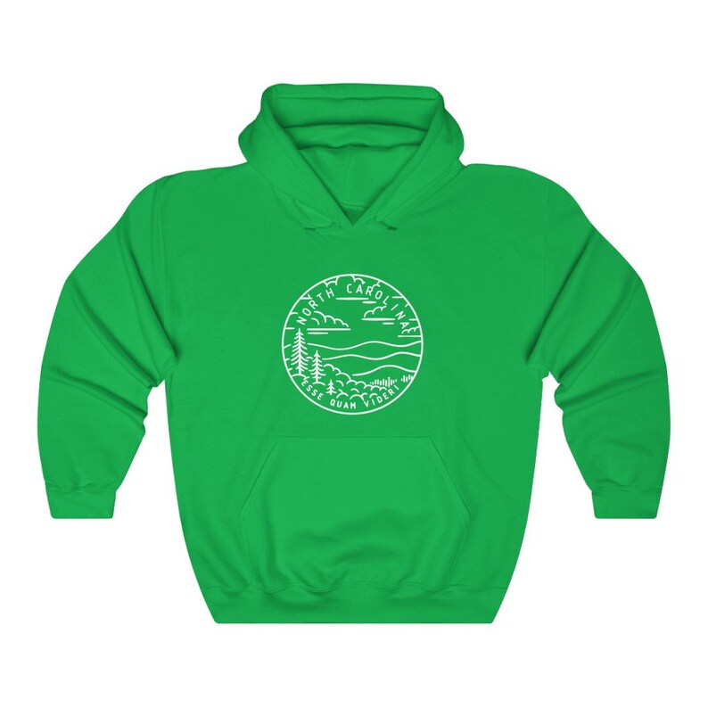 May include: A green hooded sweatshirt with a white outline of a circle containing the words "North Carolina" and "Esse Quam Videri" with a mountain and tree design.
