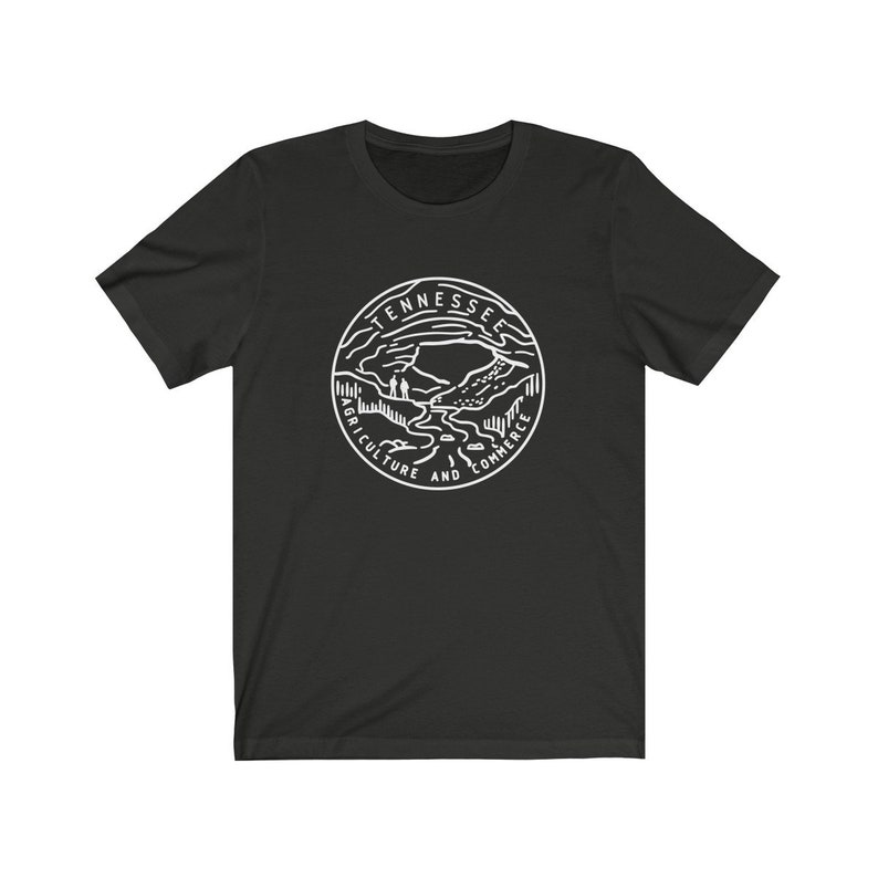 May include: Black t-shirt with a white outline of the state seal of Tennessee. The seal features a mountain range, a river, and the words "Agriculture and Commerce".