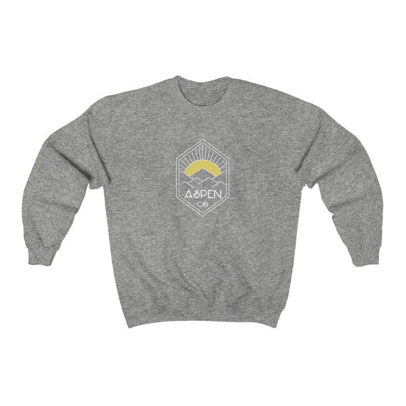 May include: A heather gray sweatshirt with a white graphic of a mountain range with a yellow sun rising behind it. The graphic is inside a geometric shape and says "Aspen Co."