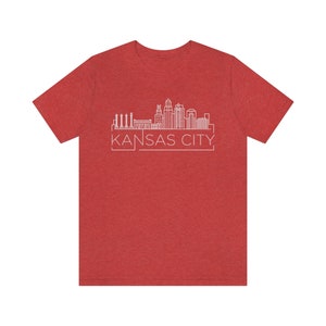 May include: Red heather t-shirt with a white outline of the Kansas City skyline and the text "KANSAS CITY" in a white box.