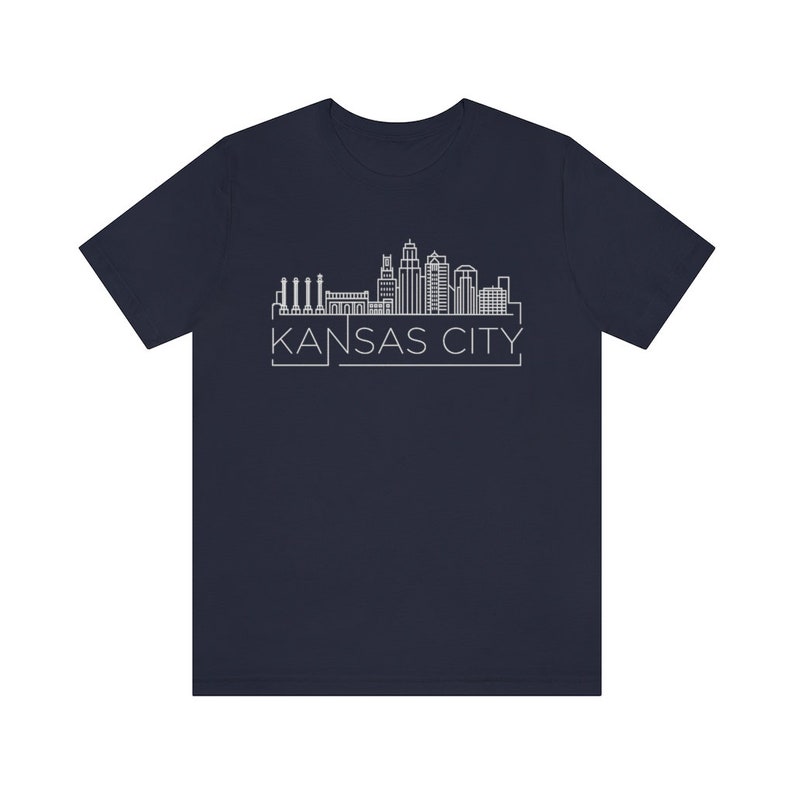 May include: A navy blue t-shirt with a white outline of the Kansas City skyline and the text "KANSAS CITY" underneath.