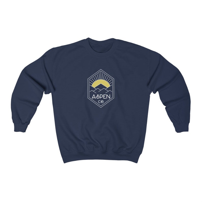 May include: Navy blue sweatshirt with a white graphic of a mountain range and a sun with the text "ASPEN CO" in a hexagon.