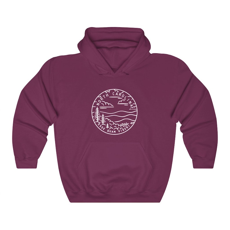 May include: A maroon hooded sweatshirt with a white outline of a circle containing the words "North Carolina" and a landscape scene with mountains and trees. The text "Esse Quam Videri" is written below the circle.