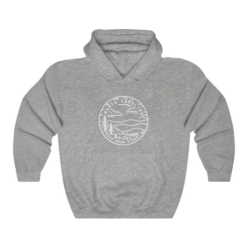 May include: Grey hooded sweatshirt with a white outline of a circle containing the words "North Carolina" and "Esse Quam Videri" with a mountain and tree design.