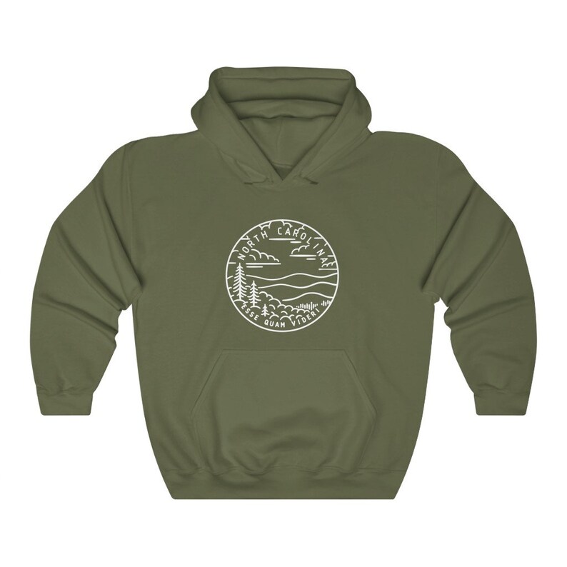 May include: A green hooded sweatshirt with a white outline of a circle containing the words "North Carolina" and "Esse Quam Videri" with a mountain and tree landscape inside.