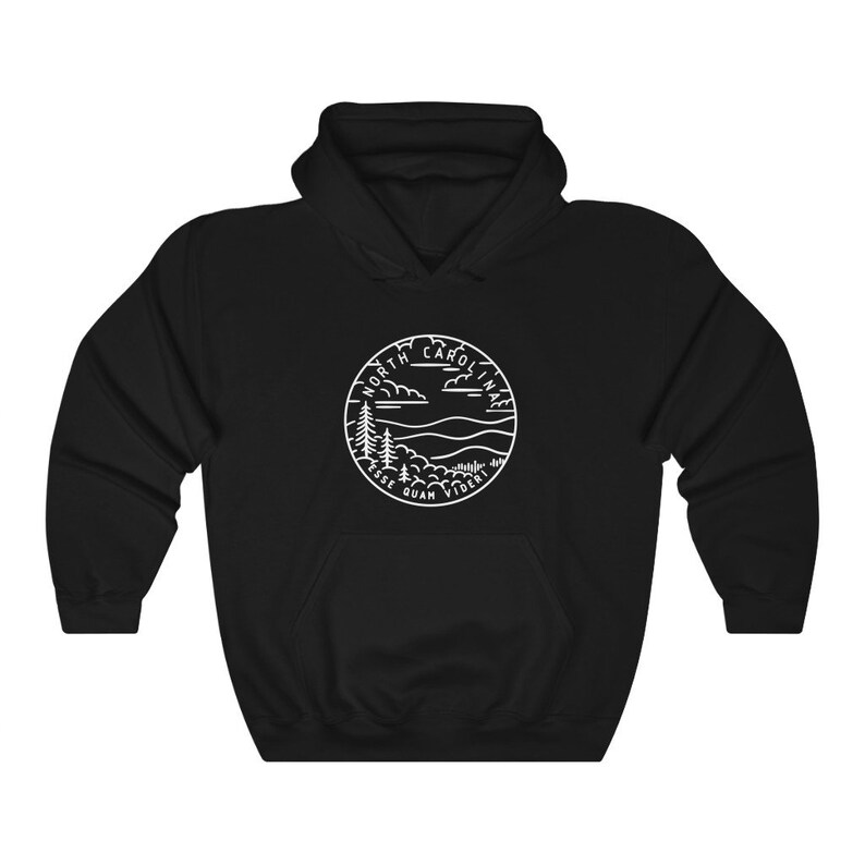 May include: Black hooded sweatshirt with a white outline of a circle containing the words "North Carolina" and "Esse Quam Videri" with a mountain and tree landscape inside.