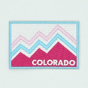 May include: White embroidered patch with a pink and blue mountain design and the word "COLORADO" in white.