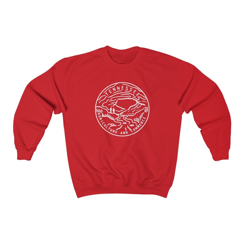 May include: Red sweatshirt with a white graphic of the Tennessee state seal. The seal features a mountain landscape with the words "Tennessee Agriculture and Commerce".