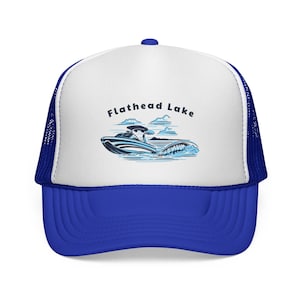 May include: A trucker hat with a white front panel and a blue brim and mesh back. The hat features the text "Flathead Lake" above a graphic of a jet ski on the water, with blue and white accents.