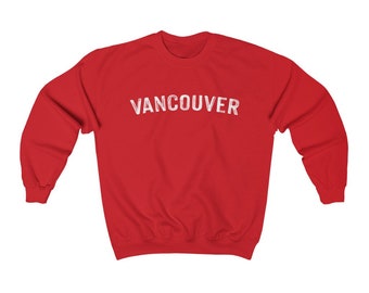 May include: Red sweatshirt with the word "VANCOUVER" printed in white on the front.
