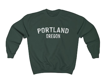 May include: A dark green sweatshirt with the text "PORTLAND OREGON" printed in white on the front.