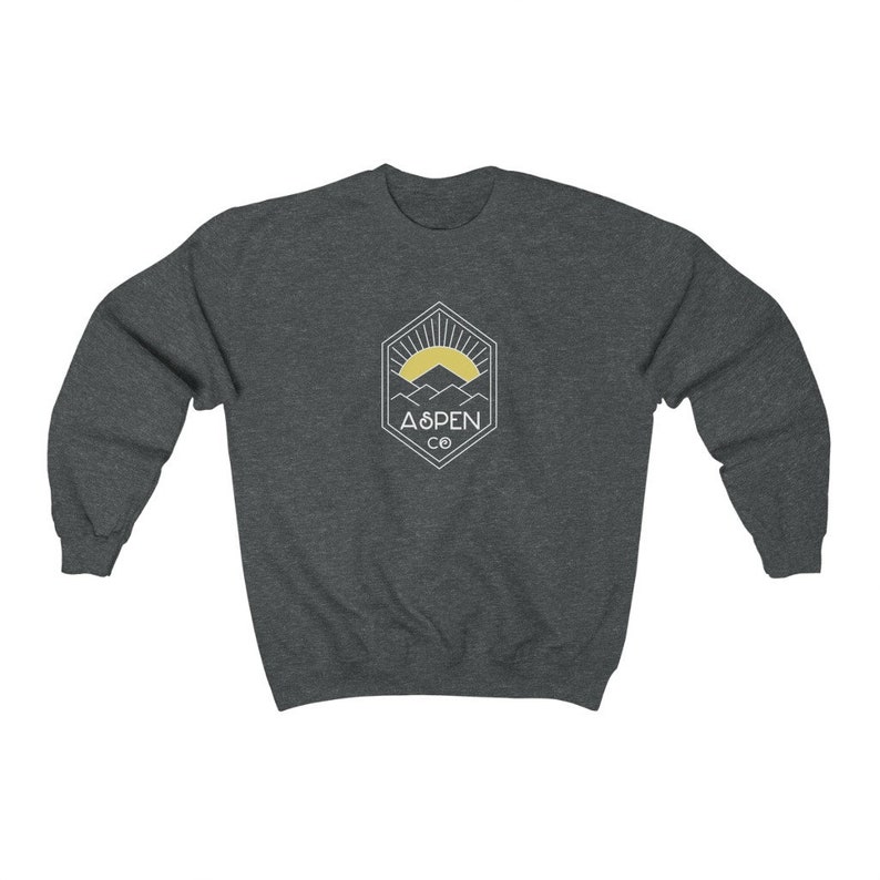 May include: A dark gray sweatshirt with a white graphic of a mountain range and a sun with the text "ASPEN CO" in a hexagon.